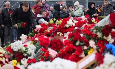 People place flowers at a memorial outside Crocus City Hall in Moscow on Sunday following Friday's deadly attack on a concert venue in Moscow