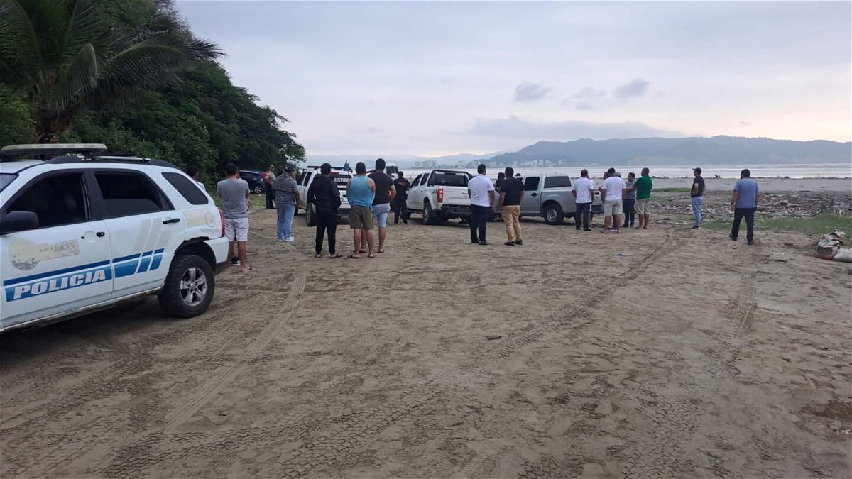 Ecuadorian police and people gather at the scene where Ecuador's youngest mayor, Brigitte Garcia was found shot dead in a car, according to the police, near San Vicente, Ecuador, in this handout image released on March 24.