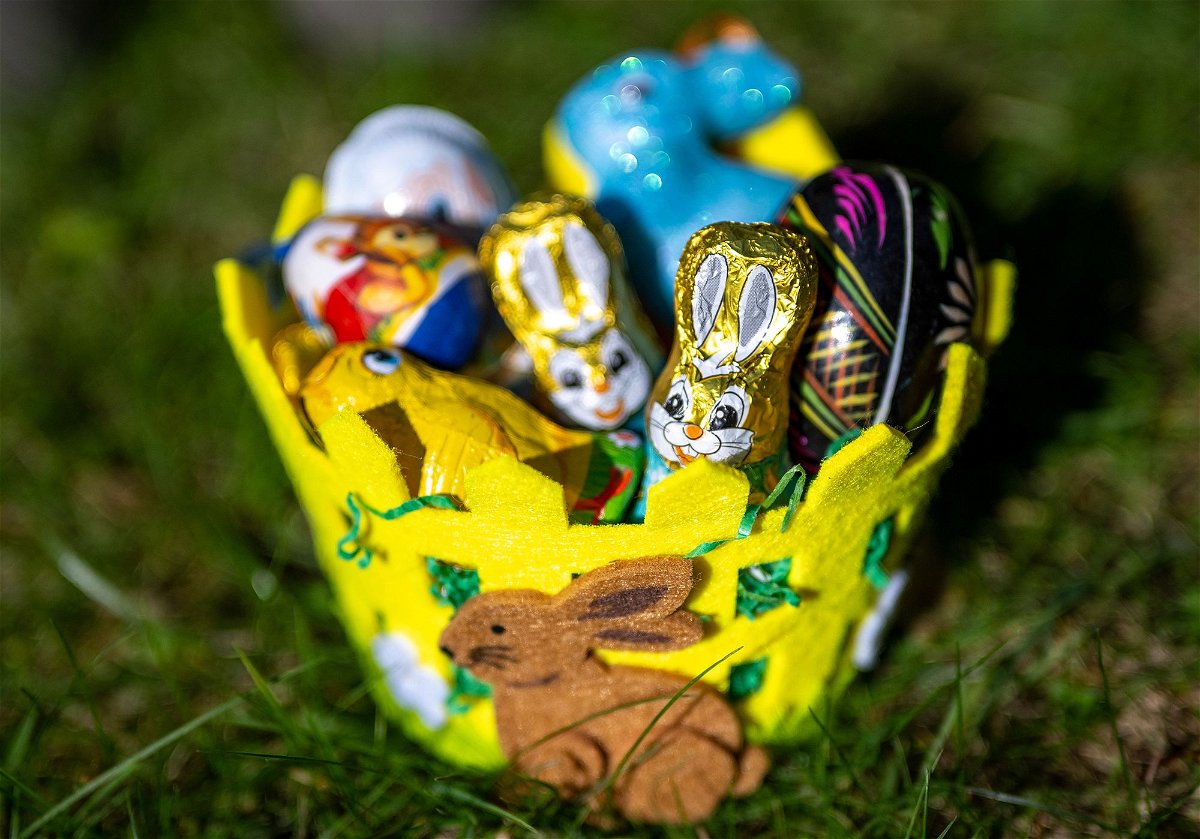 An Easter basket filled with chocolate figures and decorative eggs sits in a garden on March 18, in Berlin, Germany.