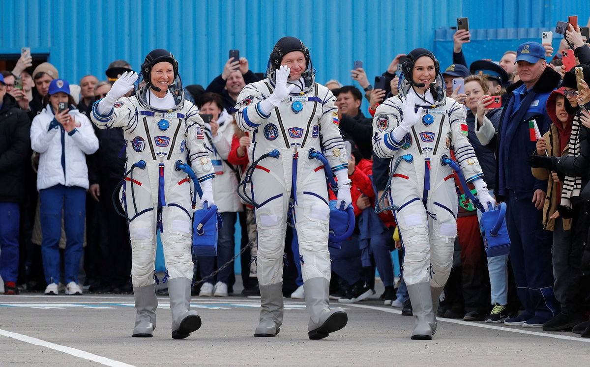 <i>Pavel Mikheyev/Pool/Reuters via CNN Newsource</i><br/>NASA astronaut Tracy Dyson (left) along with Roscosmos cosmonaut Oleg Novitskiy and spaceflight participant Marina Vasilevskaya of Belarus wave toward the crowd while heading to the launchpad at the Baikonur Cosmodrome in Kazakhstan.