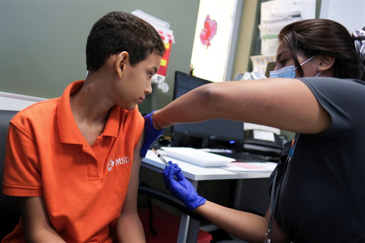 A registered nurse injects a dose of the dengue vaccine to Alberto Luis Nunez, 12, after a spike in dengue cases in San Juan, Puerto Rico, this month.
