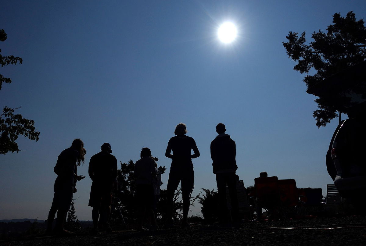 People gather near Redmond, Oregon, in August 2017 to view a total solar eclipse as the celestial event approaches. Shallow cumulus clouds start dissipating in large proportions when only a fraction of the sun is covered, a new study says.