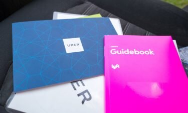 New driver manuals for Uber and Lyft drivers are displayed in a 2018 photo.