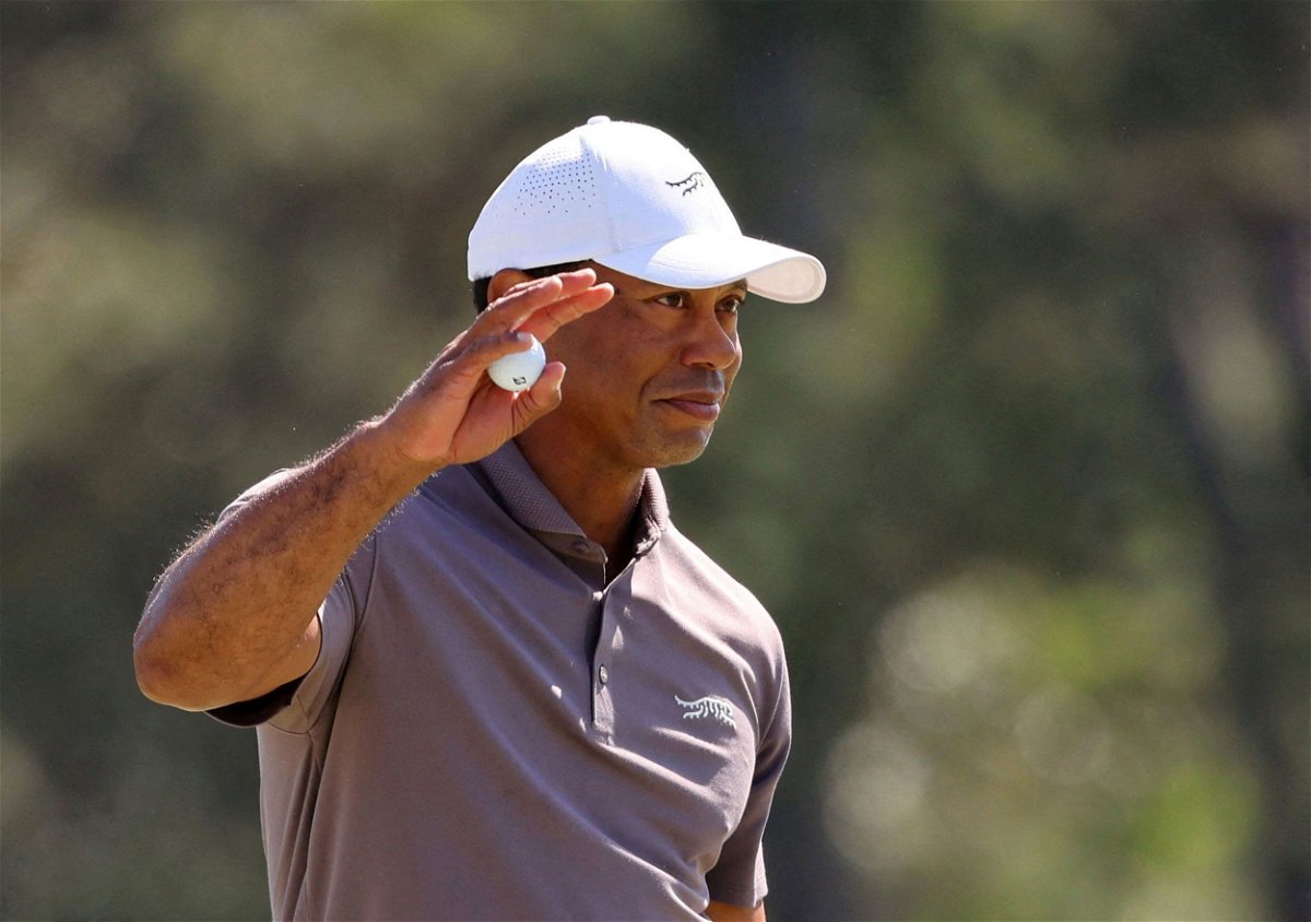 <i>Mike Blake/Reuters via CNN Newsource</i><br/>Tiger Woods acknowledges the crowd on the 18th green after completing his second round to secure a record-breaking 24th consecutive cut at the Masters.