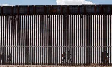 Migrants walk along the Mexico-US border after the the Republican-backed Texas law known as SB 4 took effect on March 19.