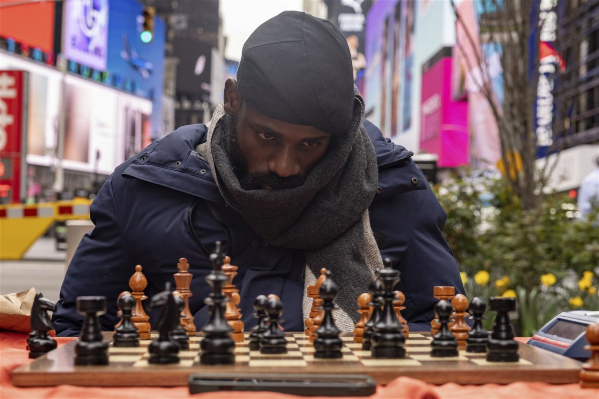 <i>Yuki Iwamura/AP via CNN Newsource</i><br/>People celebrate as Tunde Onakoya marks 46 hours for consecutively playing a chess game in Times Square