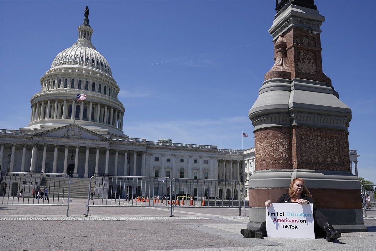 Jennifer Gay, a TikTok content creator, sits outside the U.S. Capitol, Tuesday, April 23, in Washington as Senators prepare to consider legislation that would force TikTok's China-based parent company to sell the social media platform under the threat of a ban, a contentious move by U.S. lawmakers.