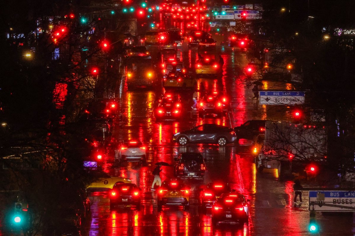 New rules from the National Highway Traffic Safety Administration will require better automatic braking by September 2029. Pedestrians and cars move along First Avenue in the Manhattan borough of New York, in the pouring rain, on February 27.
