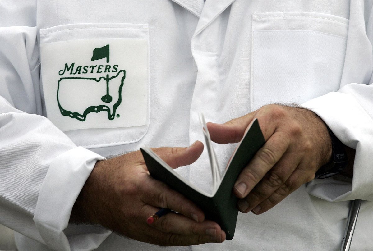 A caddie looks over his yardage book before the start of the first practice ahead of the 2006 Masters.