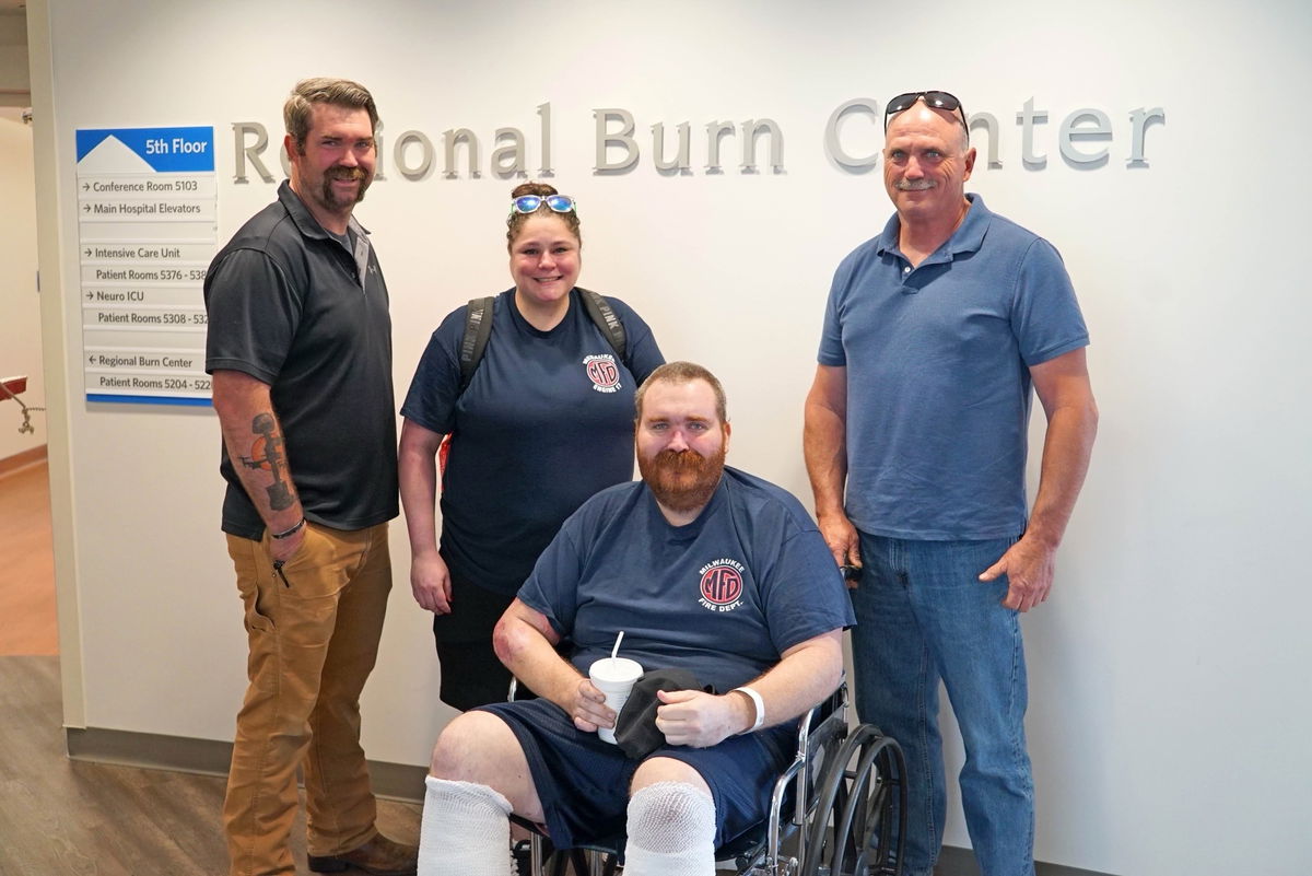 <i>Chief Aaron Lipski/WDJT via CNN Newsource</i><br/>Milwaukee Firefighter Ryan McMenamin (seated) is joined