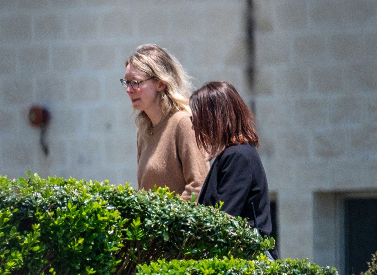 Elizabeth Holmes, left, arrives at Federal Prison Camp Bryan in Bryan, Texas in May 2023. Holmes could be out of prison several months earlier than expected.