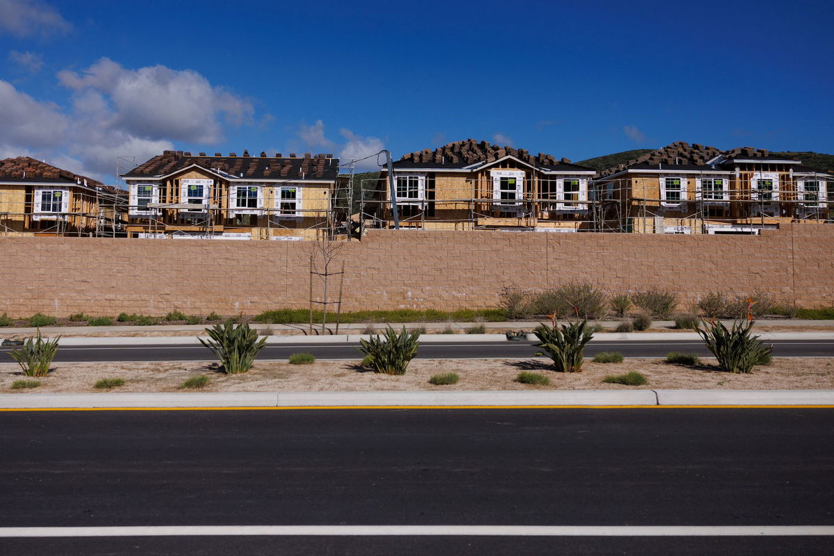 Scaffoldings are set up around single-family residential homes under construction in San Marcos, California, in March.