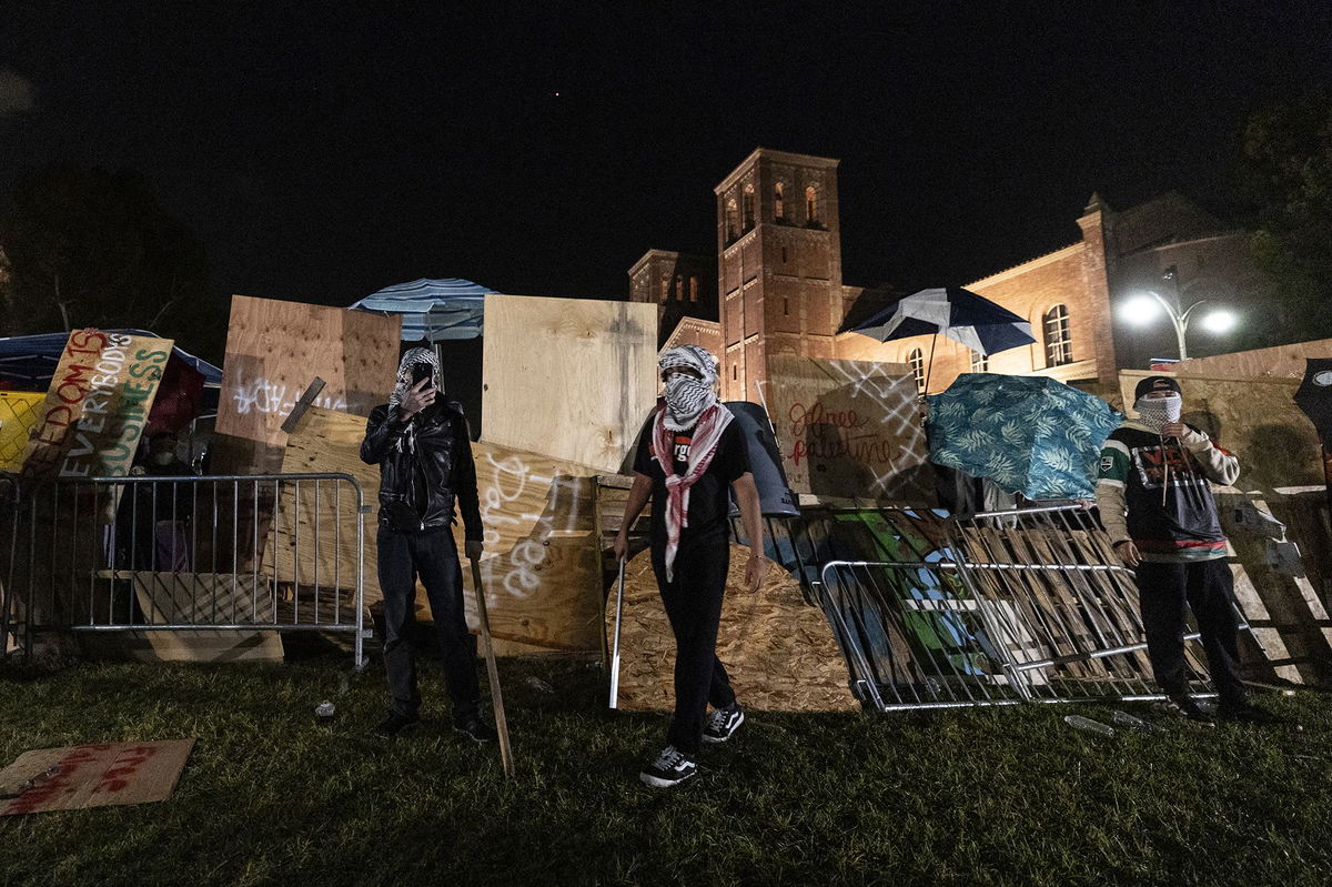 <i>Etienne Laurent/AFP/Getty Images via CNN Newsource</i><br/>Counter protesters attack a pro-Palestinian encampment set up on the campus of the University of California Los Angeles (UCLA) as clashes erupt