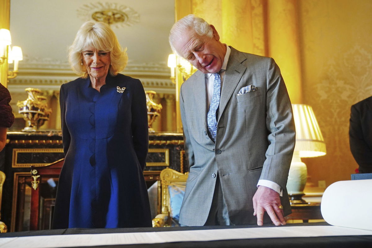 King Charles III and Queen Camilla are presented with the Coronation Roll, an official record of their Coronation, at Buckingham Palace on Wednesday.