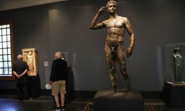 The ancient Greek statue known as "Victorious Youth" (center