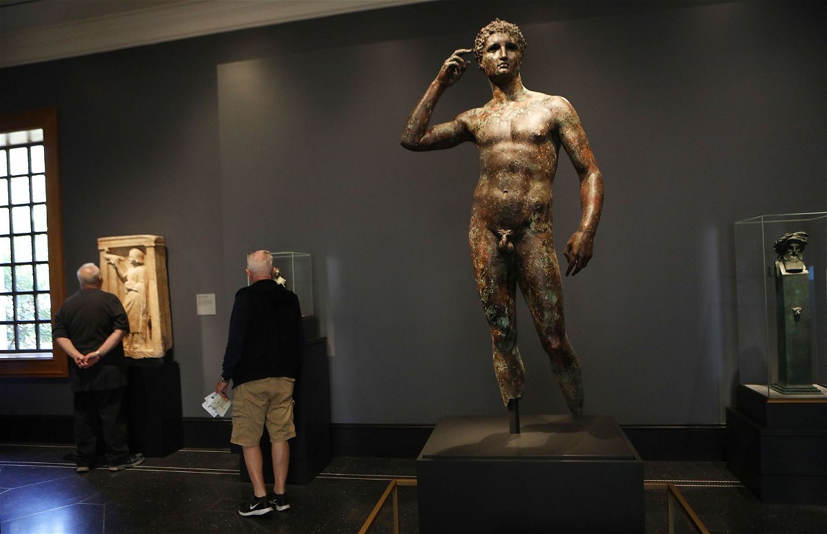 The ancient Greek statue known as "Victorious Youth" (center