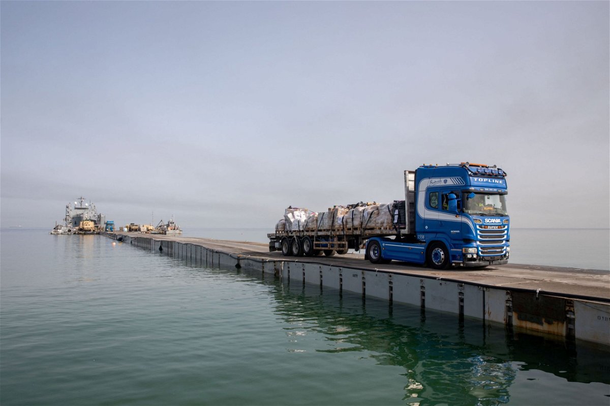<i>US Army Central/Reuters via CNN Newsource</i><br/>A truck carries humanitarian aid across Trident Pier