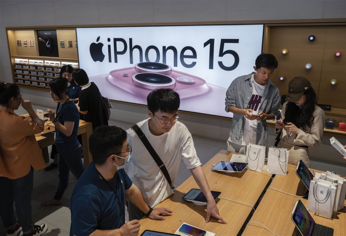 People look at and buy the newly launched iPhone 15 and other Apple products at a flagship store, in September 2023 in Beijing, China.
