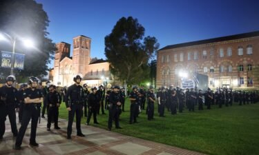 LAPD officers keep watch near a pro-Palestinian encampment at the University of California