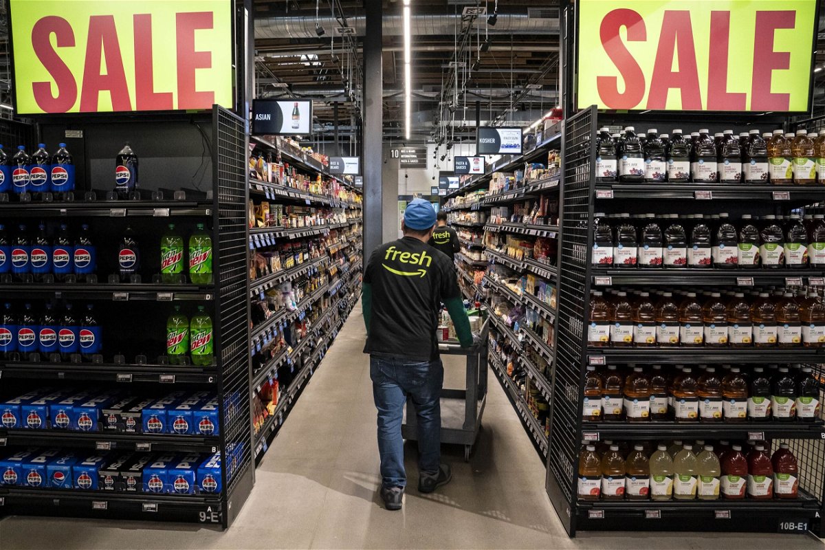 Workers stock shelves at an Amazon Fresh grocery store in Seattle, Washington, on May 2.
Mandatory Credit:	
