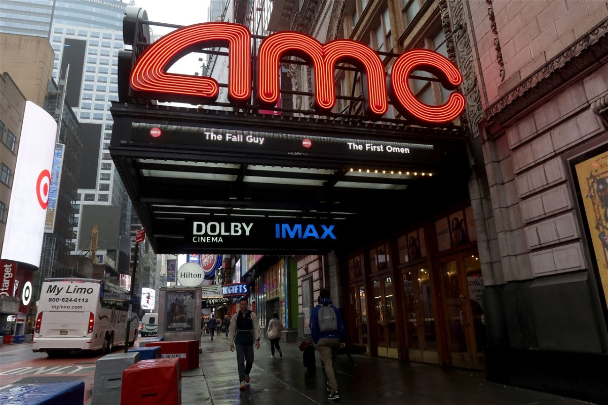 People walk past an AMC movie theater on 42nd Street in Times Square on May 16, 2024, in New York City.