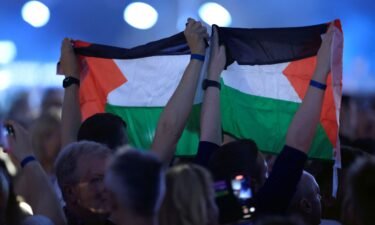 Audience members hold Palestinian flags in the crowd during the final dress rehearsal before the 68th edition Eurovision Song Contest final at Malmo Arena
