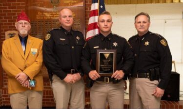 Caddo Parish sheriff's Deputy Tyler Lummus receiving Hero of the Year award from the Forty & Eight veterans organization.