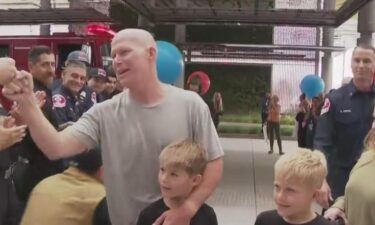 Corona Fire Department Battalion Chief Brandon Willson is cheered-on as he completes his final cancer treatment in Irvine.