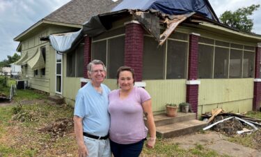 Larry Hayes (left) was approached by two men shortly after the May 25 tornado damaged its roof and electrical system.