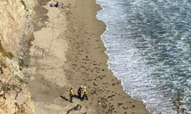 The word "HELP" made with rocks is seen on a beach during the rescue of a stranded kite surfer south of Davenport Landing in Santa Cruz County.