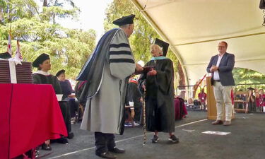 Virginia Hislop received her master's academic hoop and her diploma.