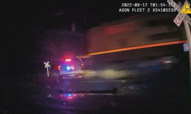 Two Colorado municipalities have reached a settlement with a woman who was seriously injured two years ago when the police patrol car she was in was struck by a freight train.