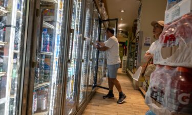 People purchase drinks in a store on a sweltering afternoon in Brooklyn on the first day of summer on June 21 in New York City. US consumer confidence teetered slightly in June.