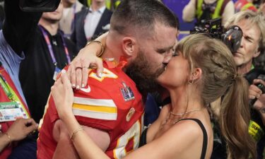 Travis Kelce kisses Taylor Swift on the field at Arrowhead Stadium after the Kansas City Chiefs beat the San Fransisco 49ers in the 2024 Super Bowl.