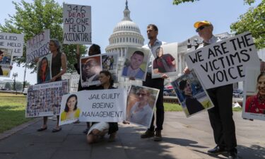 Family members of the crash victims of the Boeing 737 MAX crash in Ethiopia hold photographs during a news conference on Capitol Hill.