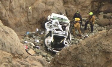 This image from the San Mateo County Sheriff's Office shows the Tesla on a rocky beach below the cliffs