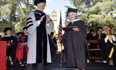 Virginia Hislop accepts her diploma for her master of arts in education at Stanford University's 2024 Graduate School of Education commencement ceremony from Dean Dan Schwartz.