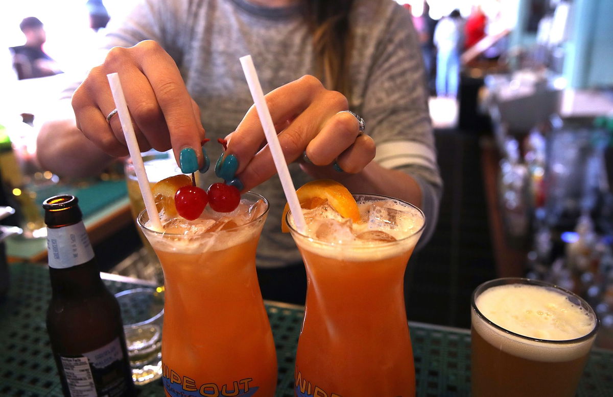 <i>Justin Sullivan/Getty Images via CNN Newsource</i><br/>A bartender at Wipeout Bar & Grill makes cocktails on June 21