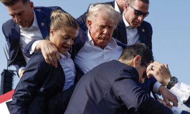 Former President Donald Trump is rushed offstage by U.S. Secret Service agents after being grazed by a bullet during a rally in Butler