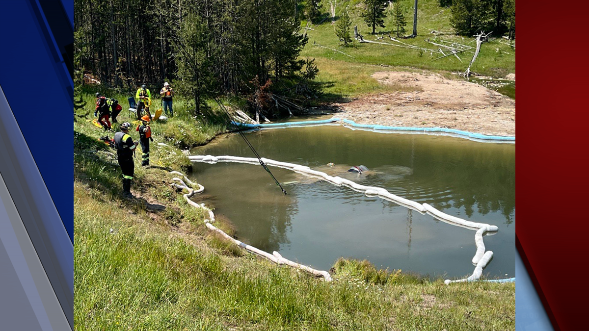 A car is submerged in the Semi-Centennial Geyser thermal feature before it is removed on  July 12, 2024.