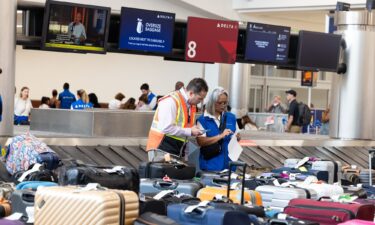 Delta employees try to locate passengers' luggage at Hartsfield-Jackson Atlanta International Airport on July 23.