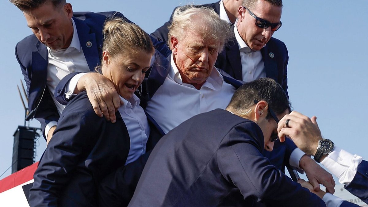 <i>Anna Moneymaker/Getty Images via CNN Newsource</i><br/>Former President Donald Trump is rushed offstage by U.S. Secret Service agents after being grazed by a bullet during a rally in Butler