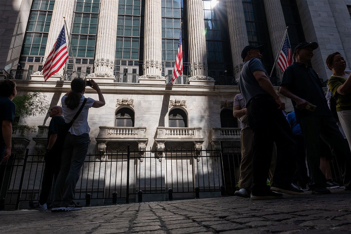 <i>Spencer Platt/Getty Images via CNN Newsource</i><br/>People walk through the Financial District near the New York Stock Exchange on July 11