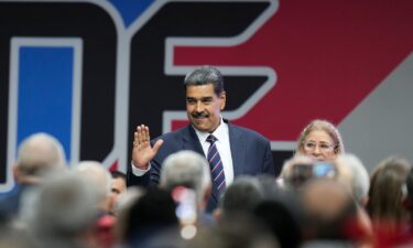 Venezuelan President Nicolas Maduro arrives with his wife Cilia Flores for a ceremony where the National Electoral Council (CNE) certified he won the presidential election.