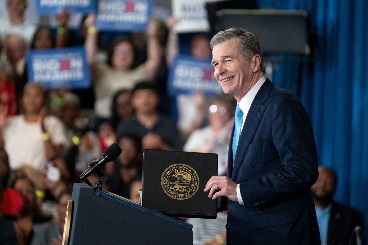 <i>Allison Joyce/AFP/Getty Images via CNN Newsource</i><br/>North Carolina Gov. Roy Cooper speaks at a Biden Harris campaign event at James B. Dudley High School on July 11