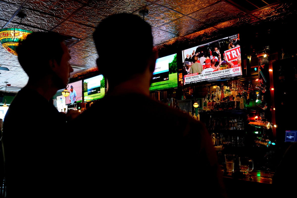 <i>Al Drago/Bloomberg/Getty Images via CNN Newsource</i><br/>A TV displays news from former President Donald Trump's rally in Butler