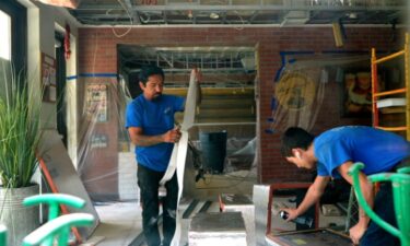 Workers busy renovating the interior of La Trattoria in Naples after the ceiling collapsed