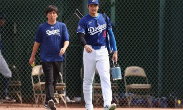 Shohei Ohtani #17 of the Los Angeles Dodgers and interpreter Ippei Mizuhara arrive to a game against the Chicago White Sox at Camelback Ranch on February 27