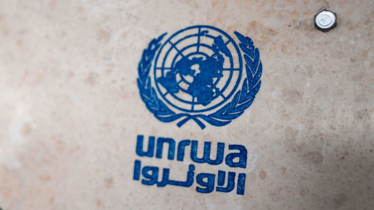 <i>Fabian Sommer/picture alliance/Getty Images via CNN Newsource</i><br/>UNRWA's lettering on a sign at the girls' school in the Talibeh refugee camp.