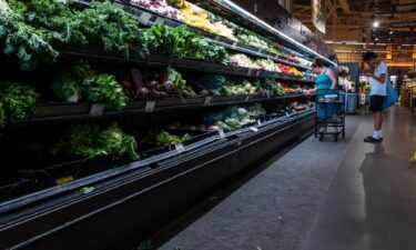 People shop at a grocery store on July 11